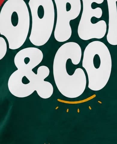 Close-up of the white Friends of Looped & Co print on green